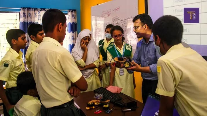 After-School — students coding on laptops